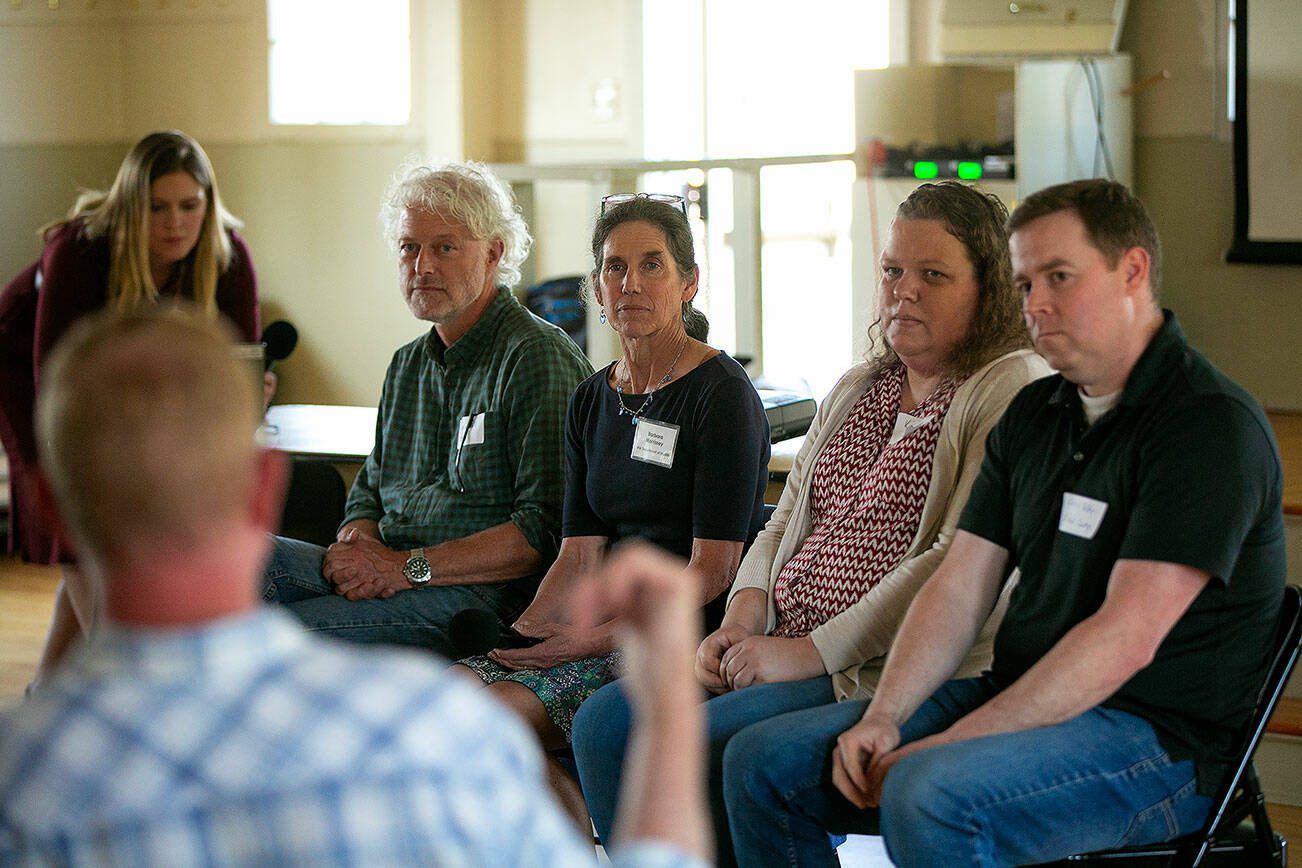 Representatives from different government organizations listen to a Harrington Lagoon resident speak about PFAS found in their drinking water during a public forum on Thursday, June 22, 2023, at the Coupeville Recreation Hall in Coupeville, Washington. From left are Claire Nitsche of the Department of Health, DOH Regional Manager Derek Pell, DOH toxicologist Barbara Morrissey, Department of Ecology’s Kim Wooten and Island County hydrogeologist Chris Kelley. (Ryan Berry / The Herald)