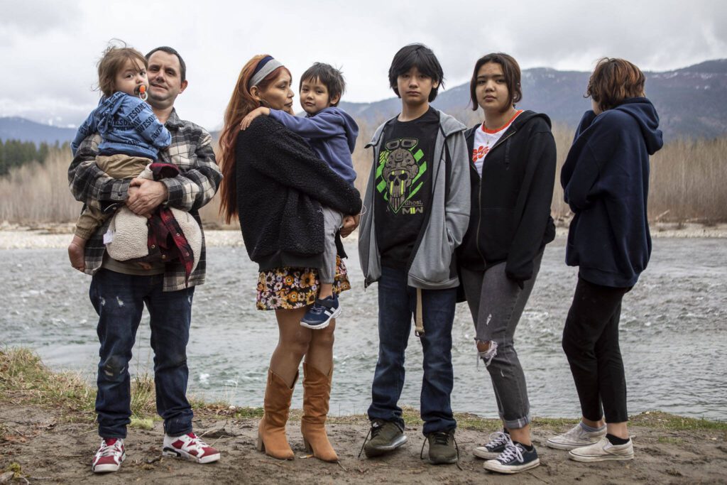 Shawn Haggard and Khrista Bill, at left, stand with their children near the Sauk-Suiattle Reservation in Darrington, Washington on Thursday, March 23, 2023. (Annie Barker / The Herald)
