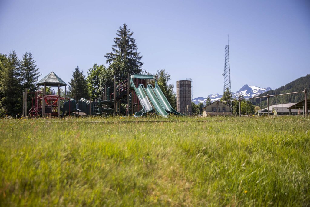 An overgrown playground sits empty on the Sauk-Suiattle Reservation on Tuesday, June 6, 2023 in Darrington, Washington. (Olivia Vanni / The Herald)
