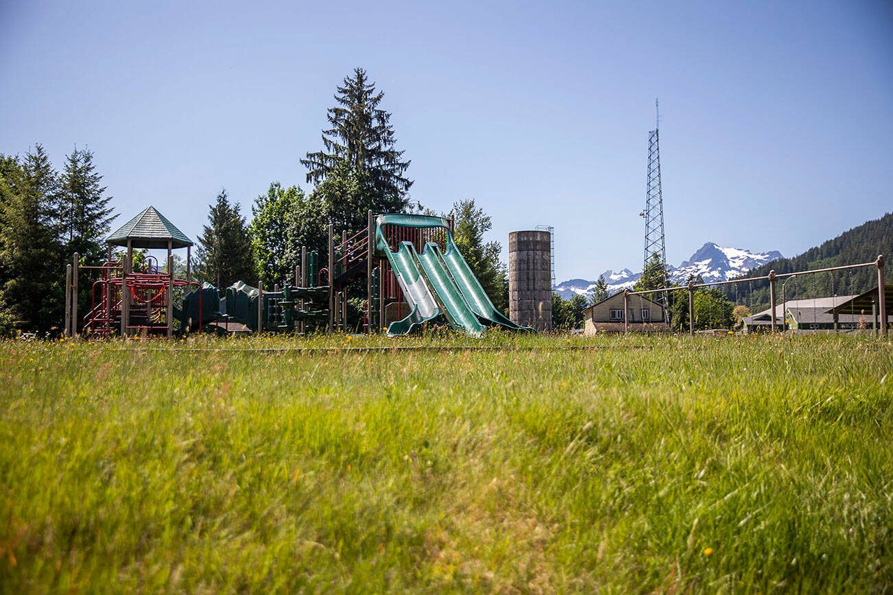 An overgrown playground sits empty on the Sauk-Suiattle Reservation on Tuesday, June 6, 2023 in Darrington, Washington. (Olivia Vanni / The Herald)