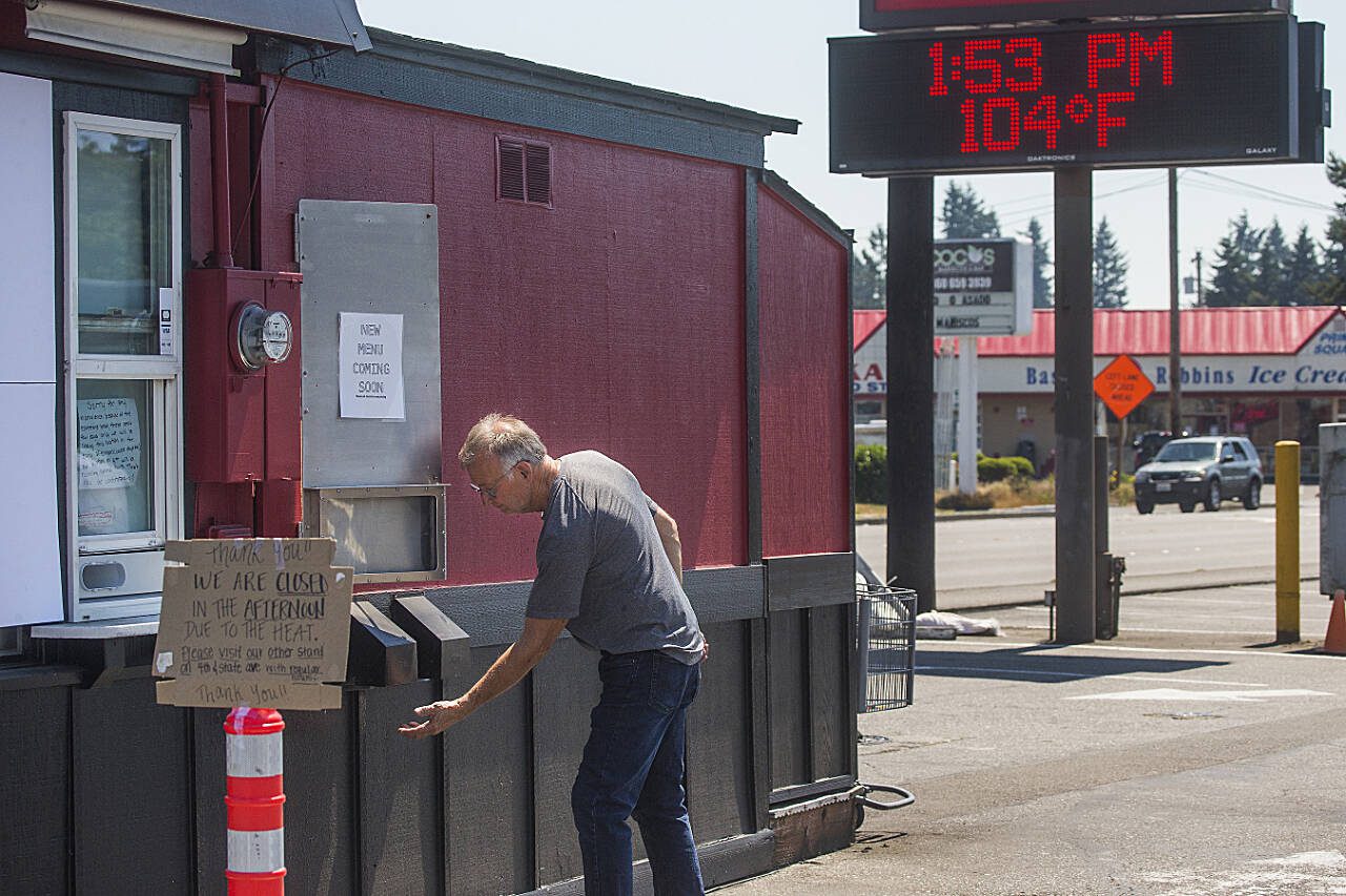 Jim Martin, owner of Espresso Connection, feels the heat from a vent at one of his coffee stands, closed for the afternoon because of excessive heat, on June 28, 2021 in Marysville. (Andy Bronson / The Herald file photo)