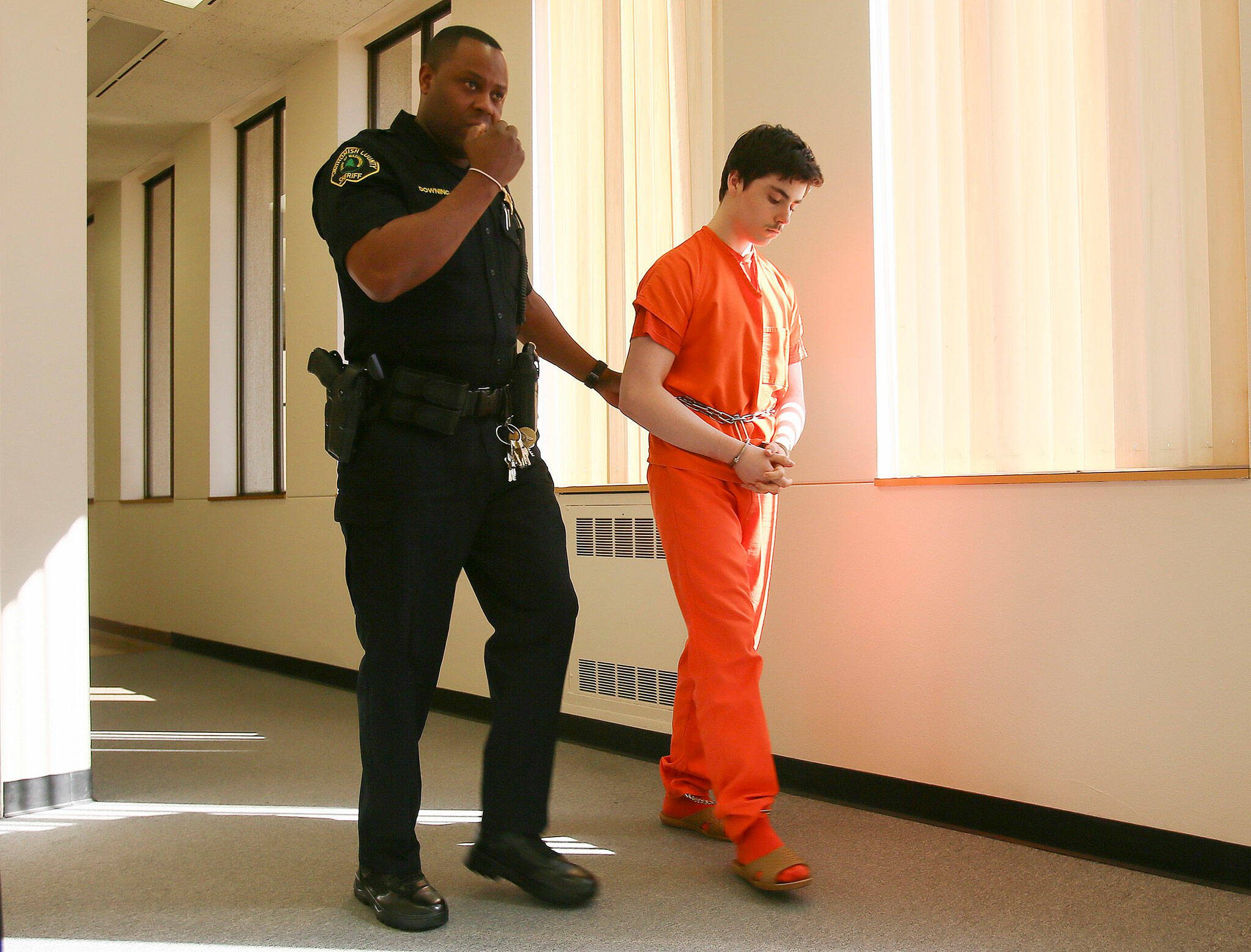 Brad George, 17, is walked to a courtroom in Everett on April 2015. (Kevin Clark / The Herald)