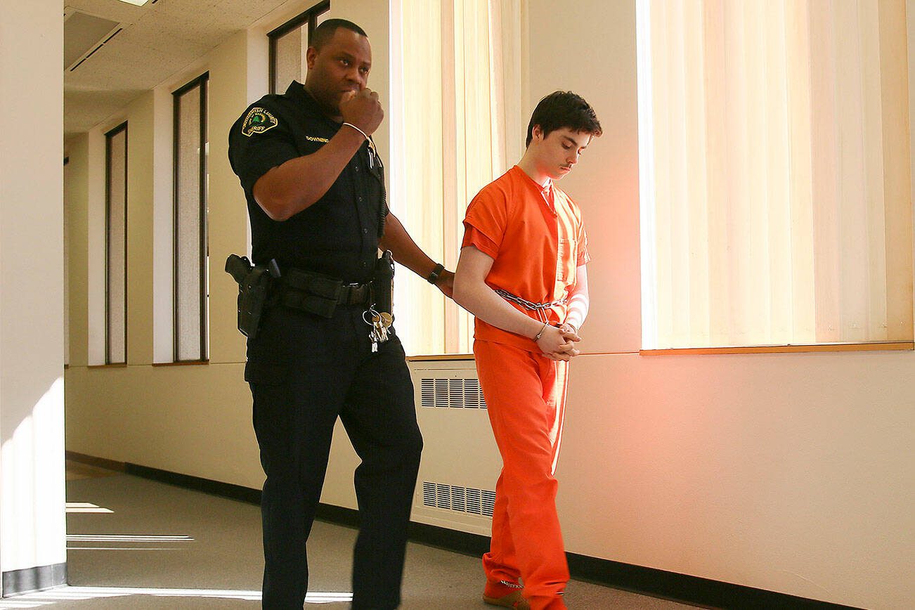 Brad George, 17, is lead back to the courtroom to continue his sentencing hearing Thursday afternoon at the Snohomish County Courthouse in Everett, Washington on April 9, 2015. (Kevin Clark / The Herald)