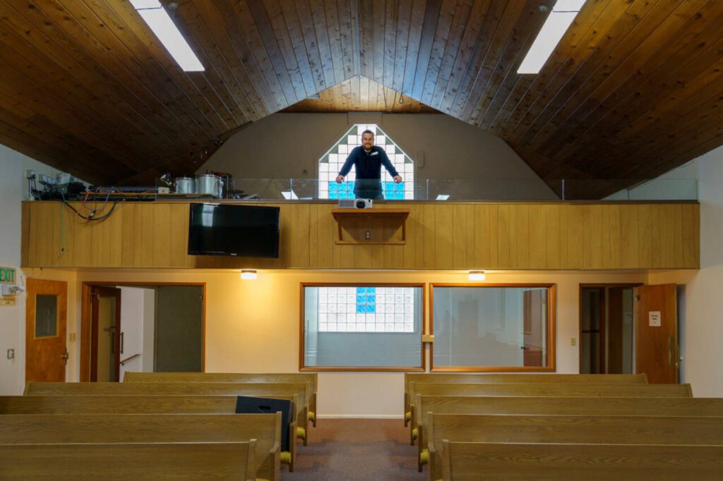 Paul Grubb stands in the choir loft of the Little Brown Church. (Photo by David Welton)
