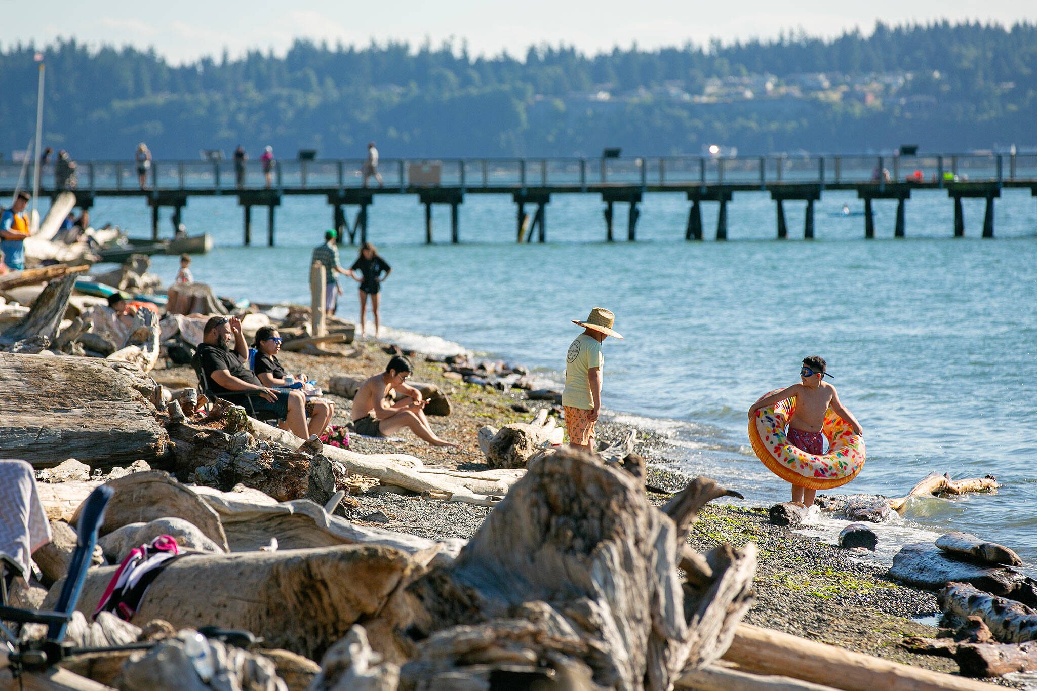 Weekend vacationers take to the beach on a warm and sunny afternoon at Kayak Point on July 1, 2023, in Stanwood, Washington. Daily highs in Snohomish County are expected to spike into the 80s during the middle of the week, according to data from the National Weather Service. (Ryan Berry / The Herald)
