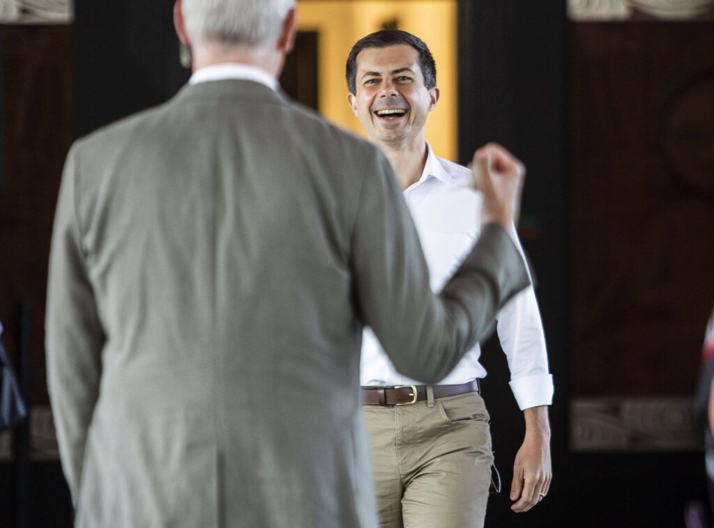 U.S. Transportation Secretary Pete Buttigieg smiles while he is greeted by U.S. Representative Rick Larsen before the start of his tour of Mukilteo Ferry Terminal on Thursday, July 6, 2023 in Mukilteo, Washington. (Olivia Vanni / The Herald)
