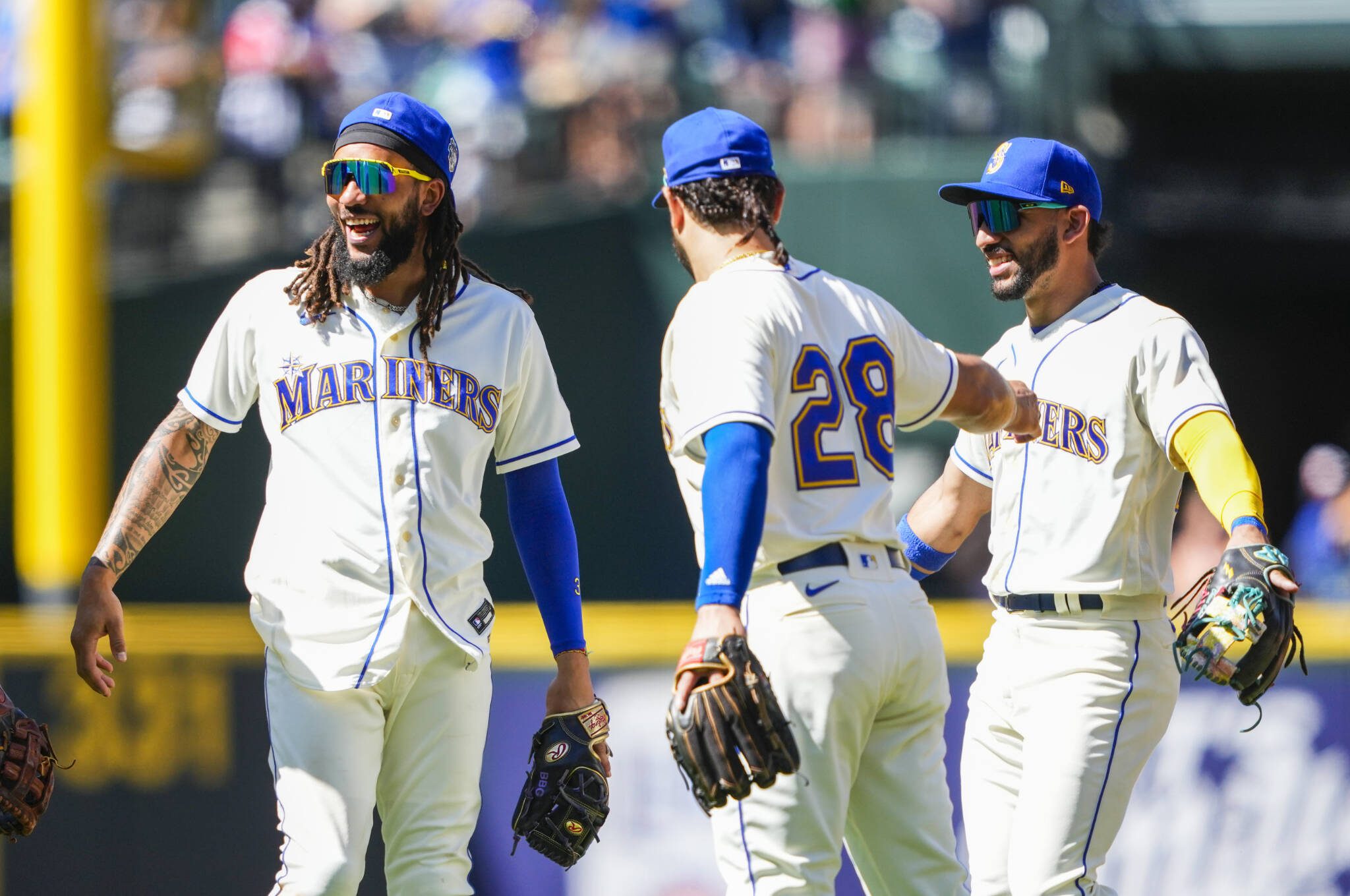 Mariners shortstop J.P. Crawford smiles with teammates third baseman Eugenio Suarez and second baseman Jose Caballero (right) as they celebrate a win over the Rays on Sunday in Seattle. (AP Photo/Lindsey Wasson)