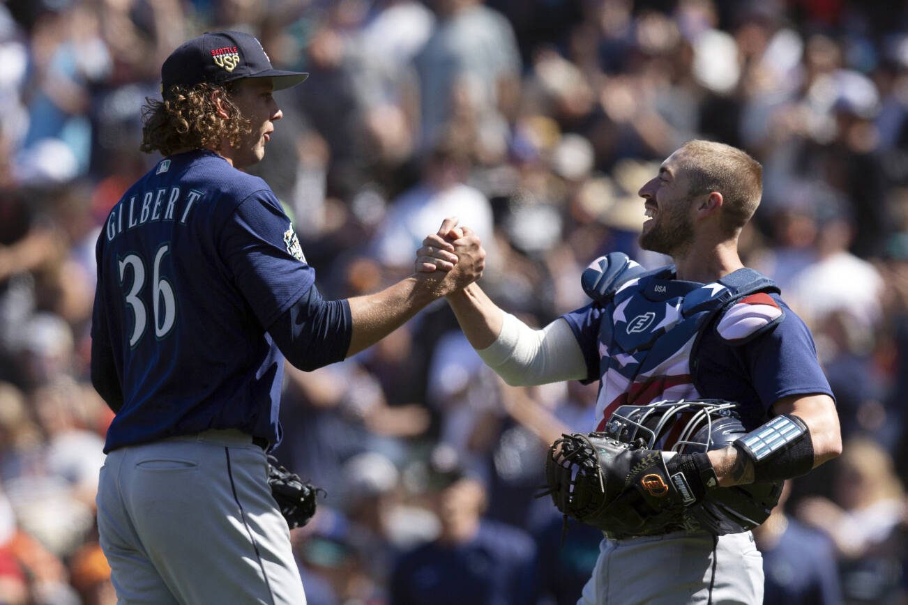 Seattle Mariners starting pitcher Logan Gilbert (36) and catcher Tom Murphy celebrate Gilbert's five-hitter against the San Francisco Giants in a baseball game, Tuesday, July 4, 2023, in San Francisco. The Mariners won 6-0. (AP Photo/D. Ross Cameron)