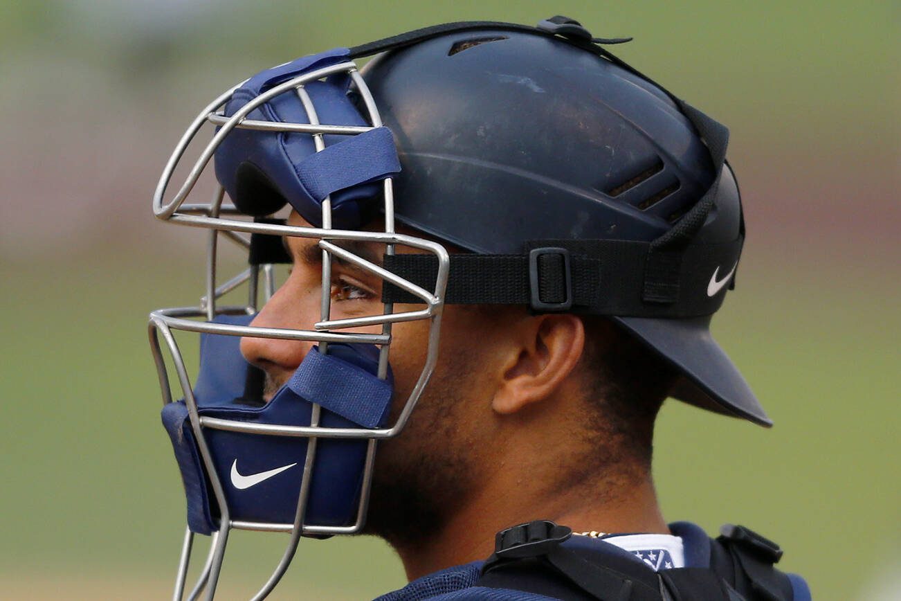 AquaSox catcher Harry Ford gets settled behind the plate before the first inning of the season opener against the Eugene Emeralds on Friday, April 7, 2023, at Funko Field in Everett, Washington. (Ryan Berry / The Herald)