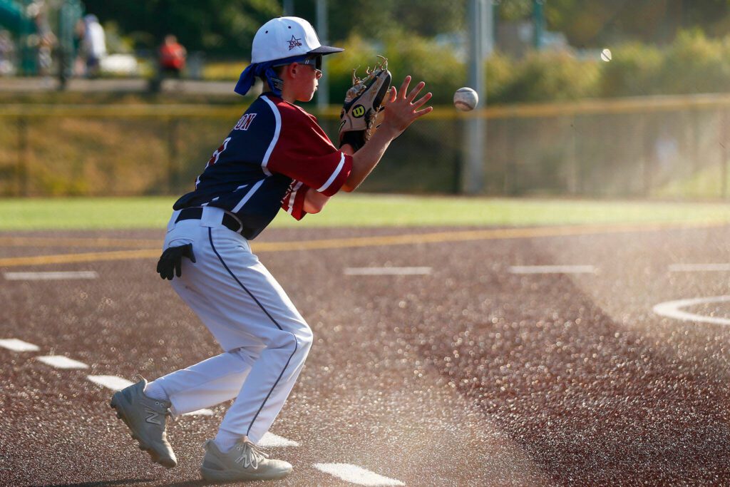 Everett All Star Ethan Nelson charges and fields a grounder at third against Lake Stevens during a 12u Little League matchup on Wednesday, July 5, 2023, at the Phil Johnson Ballfields in Everett, Washington. (Ryan Berry / The Herald)
