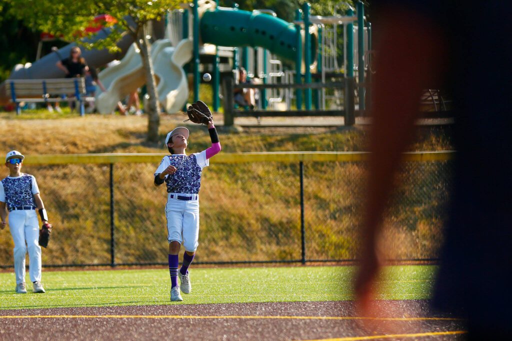 Lake Stevens All Star Jaxson Pugmire secures a pop fly at second base against Everett during a 12u Little League matchup on Wednesday, July 5, 2023, at the Phil Johnson Ballfields in Everett, Washington. (Ryan Berry / The Herald)
