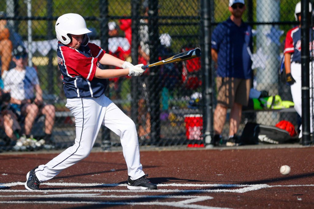 Everett All Star Waylon van de Wouw hits a ball right back to the Lake Stevens pitcher during a 12u Little League matchup on Wednesday, July 5, 2023, at the Phil Johnson Ballfields in Everett, Washington. (Ryan Berry / The Herald)
