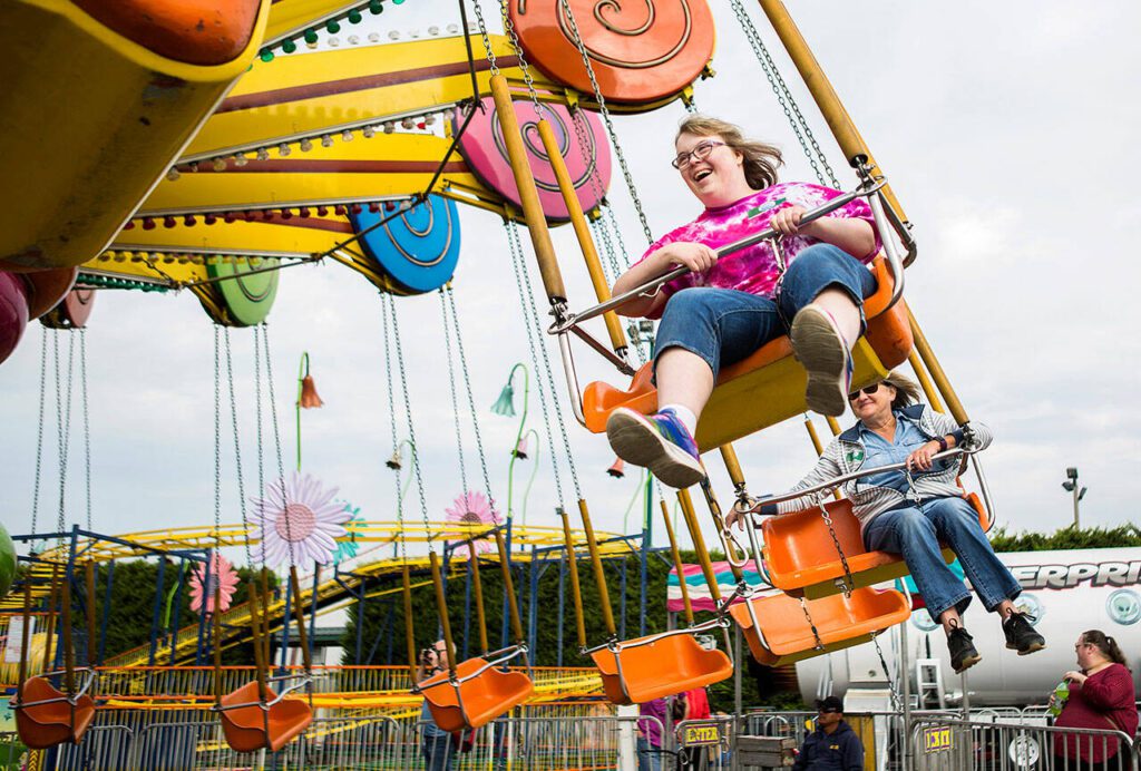 Megan Harrell, 25, smiles as she enjoy her ride during the Morning of Dreams at the Evergreen State Fair on Aug. 29, 2018 in Monroe, Wa. (Olivia Vanni / The Herald)
