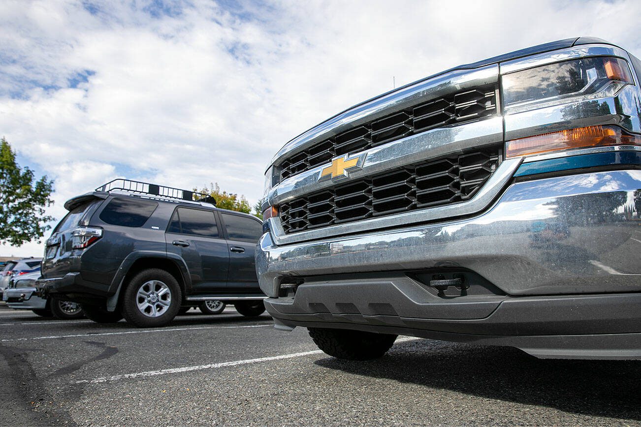 A pickup truck without a mounted front plate is parked in a parking lot Wednesday, July 12, 2023, in Marysville, Washington. The state of Washington requires front and rear plates with few exceptions. (Ryan Berry / The Herald)