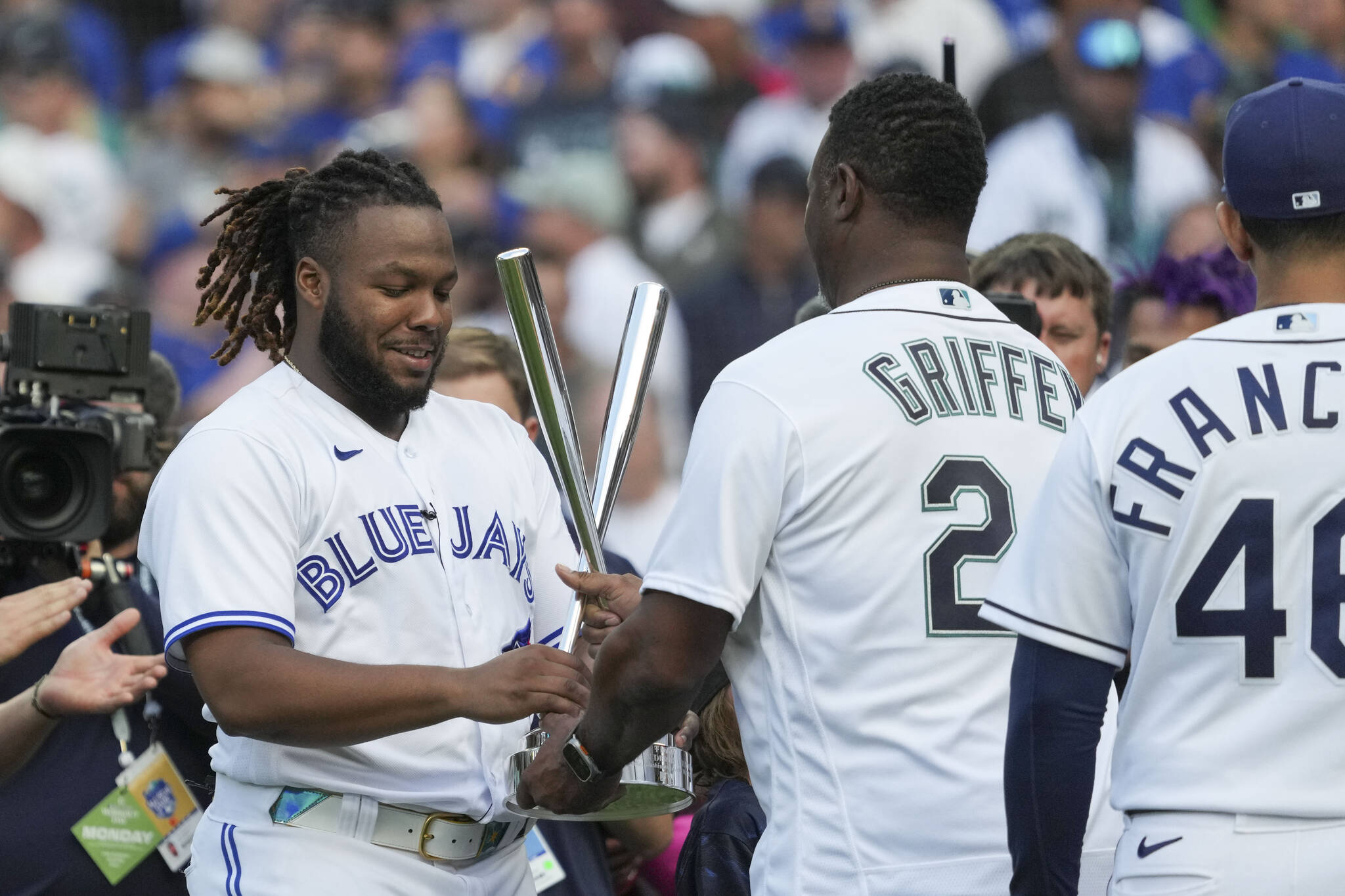 The Blue Jays’ Vladimir Guerrero Jr. accepts his trophy from former Seattle Mariner Ken Griffey Jr. after winning the MLB All-Star Home Run Derby on Monday night in Seattle. (AP Photo/Ted Warren)