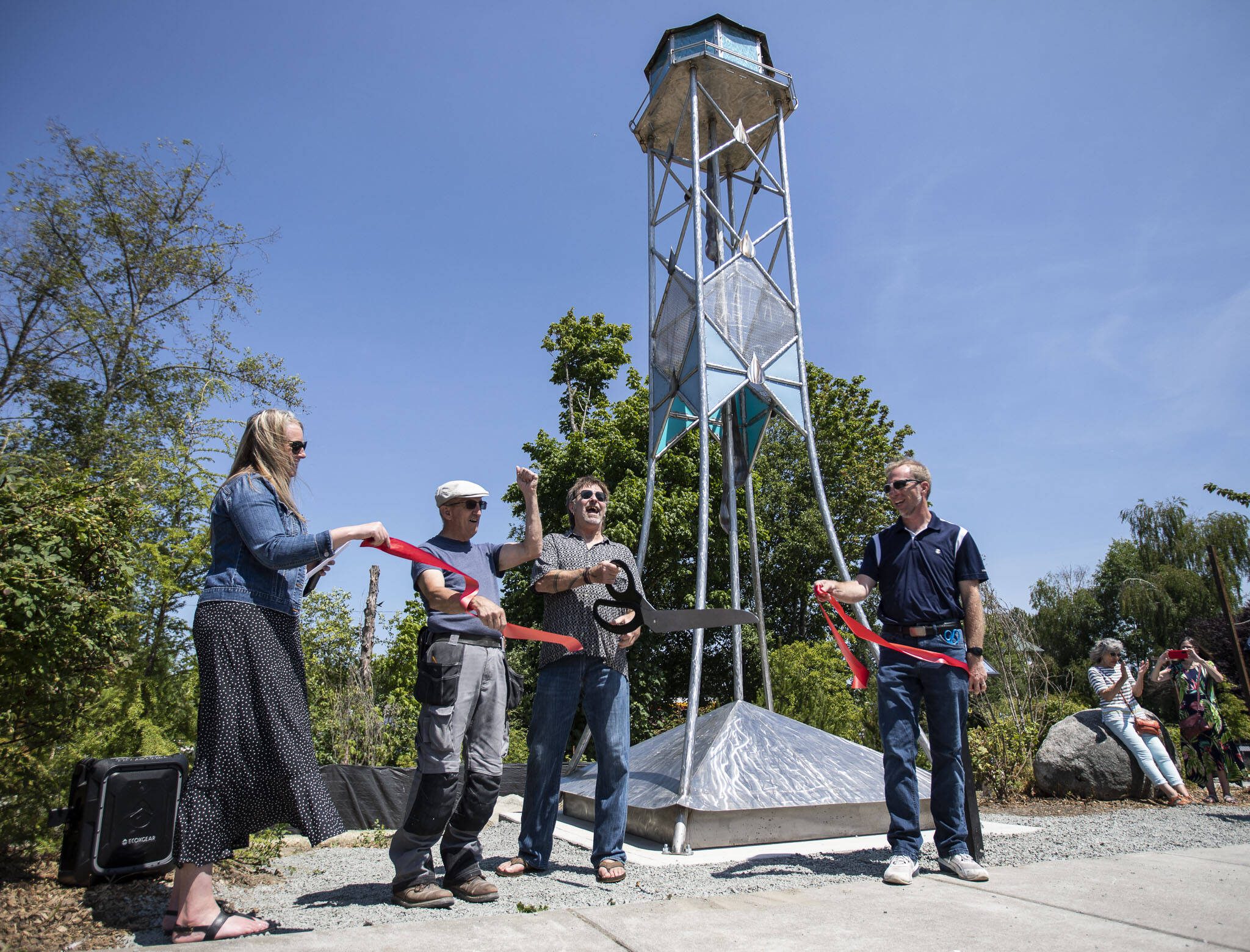 Artist Joe Powers cheers during the ribbon-cutting ceremony for his Lake Stevens Water Tower art piece on Thursday, July 20, 2023 in Lake Stevens, Washington. (Olivia Vanni / The Herald)