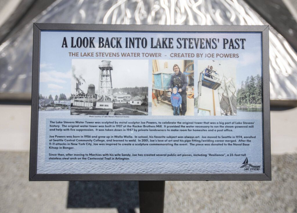 A sign explains the history of the water tower on display in front of the art piece on Thursday, July 20, 2023 in Lake Stevens, Washington. (Olivia Vanni / The Herald)
