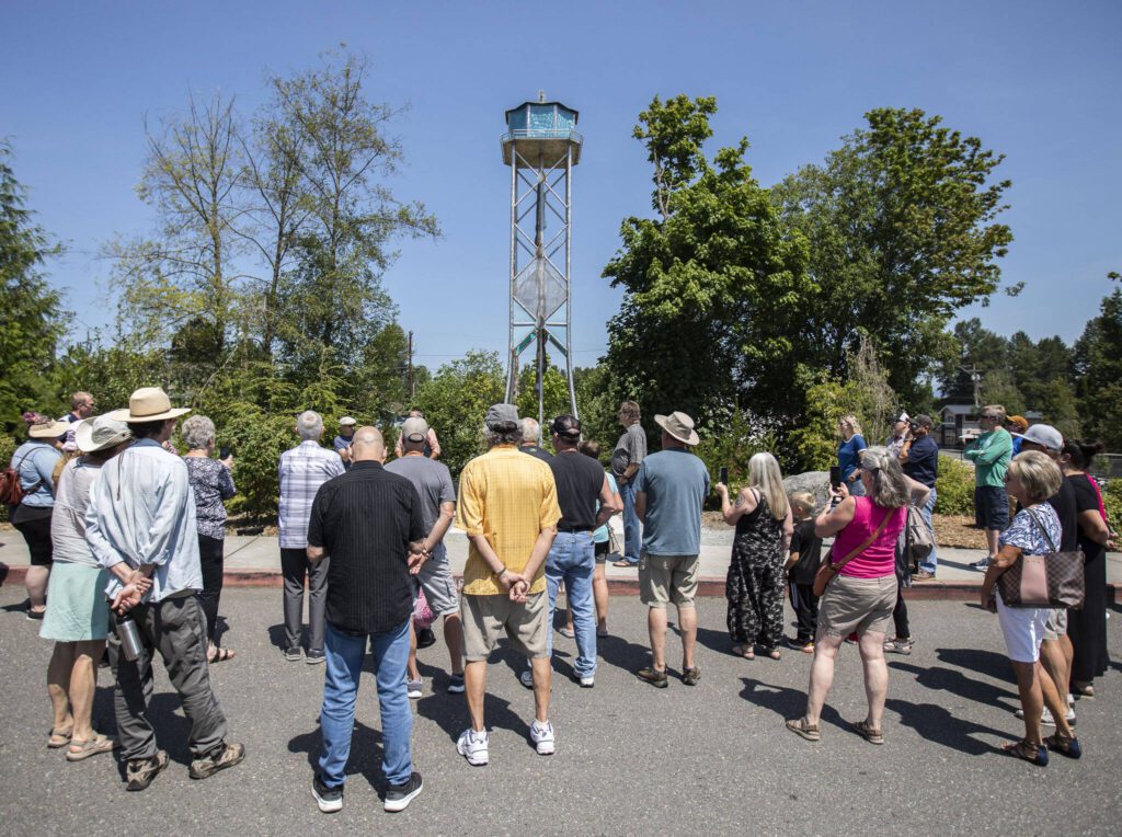 People gather for the ribbon-cutting ceremony of the Lake Stevens Water Tower art piece on Thursday, July 20, 2023 in Lake Stevens, Washington. (Olivia Vanni / The Herald)
