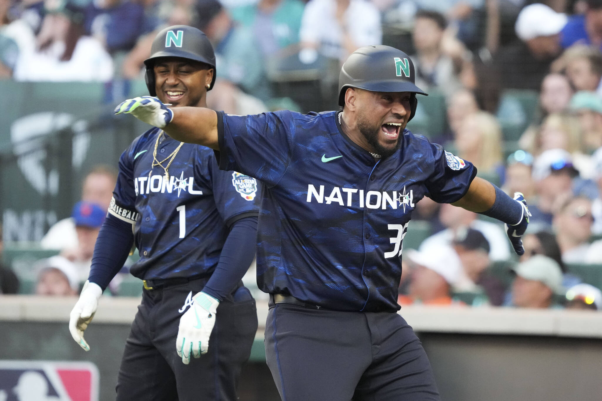 The National League’s Elias Díaz, of the Colorado Rockies, celebrates his two run home run with Ozzie Albies, of the Atlanta Braves, during the eighth inning of the MLB All-Star game on Tuesday in Seattle. (AP Photo/Ted S. Warren)