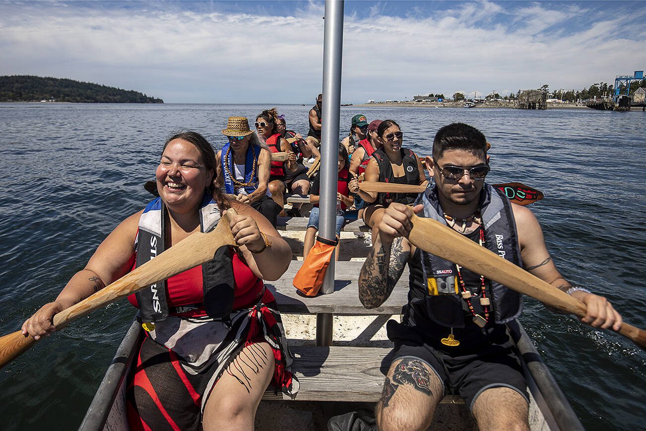 Ginger McCormick of the Tlingit and Haida tribes, left, and Austin Didrickson, 23, of the Tlingit tribe, right, paddle during the 2023 Washington Tribes Canoe Journey in Bellingham, Washington on Sunday, July 23, 2023. (Annie Barker / The Herald)