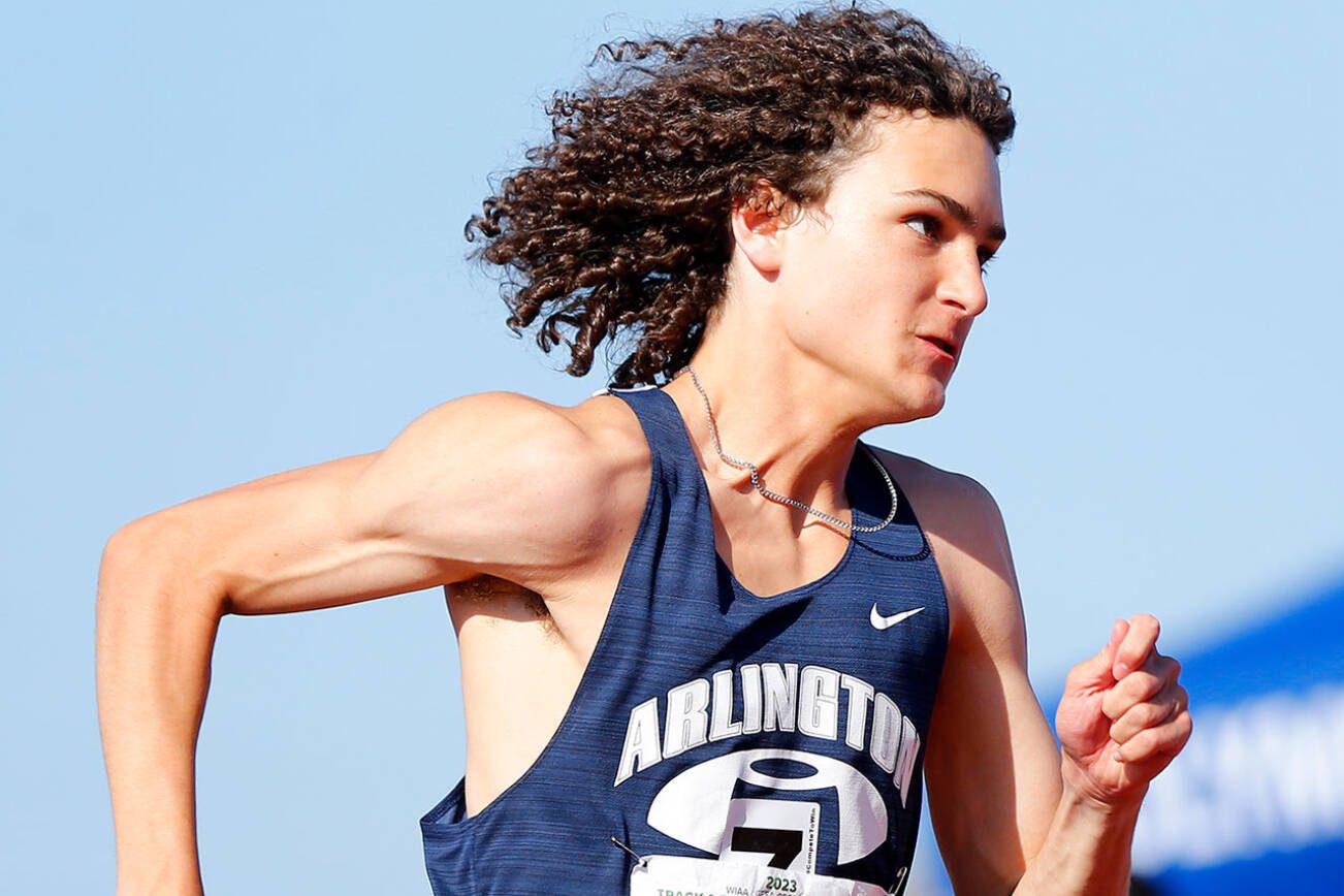 Arlington senior Kellen Langford begins the final leg of the 3A boys 4x400 meter relay during the WIAA State Track and Field Championships on Saturday, May 27, 2023, at Mount Tahoma High School in Tacoma, Washington. (Ryan Berry / The Herald)