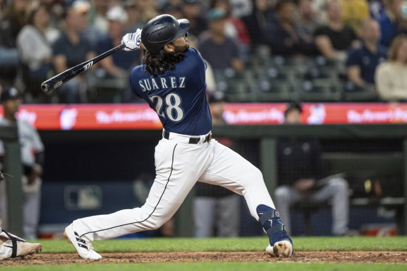 Seattle Mariners' Eugenio Suarez hits a two-run home run off Minnesota Twins relief pitcher Oliver Ortega during the seventh inning of a baseball game, Monday, July 17, 2023, in Seattle. (AP Photo/Stephen Brashear)