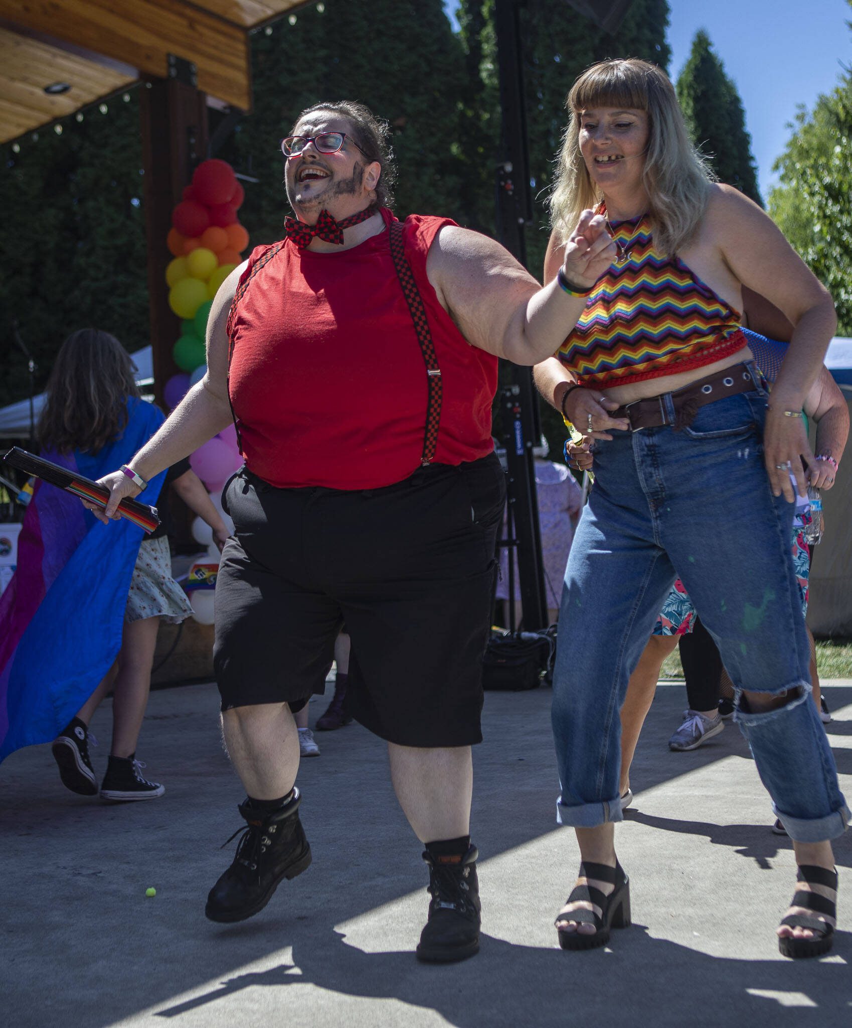 Denton Touché, 42, left, and Anya Martin, 43, right, dance during the second annual Arlington Pride at Legion Memorial Park in Arlington, Washington on Saturday, July 22, 2023. (Annie Barker / The Herald)