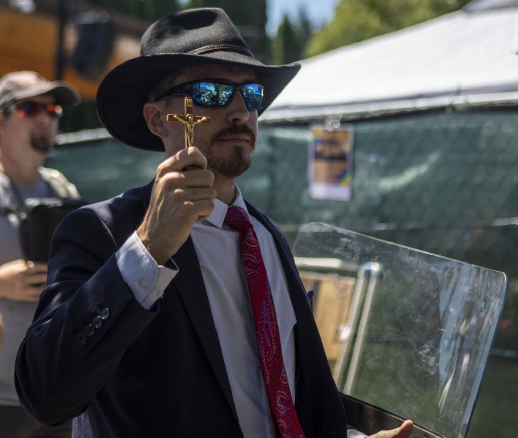 Thomas Hughes leads a protest during the second annual Arlington Pride at Legion Memorial Park in Arlington, Washington on Saturday, July 22, 2023. (Annie Barker / The Herald)
