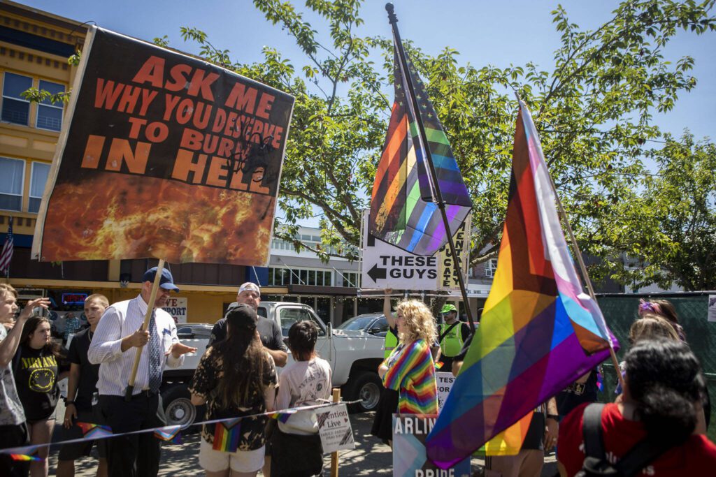Protesters and attendees interact during the second annual Arlington Pride at Legion Memorial Park in Arlington, Washington on Saturday, July 22, 2023. (Annie Barker / The Herald)
