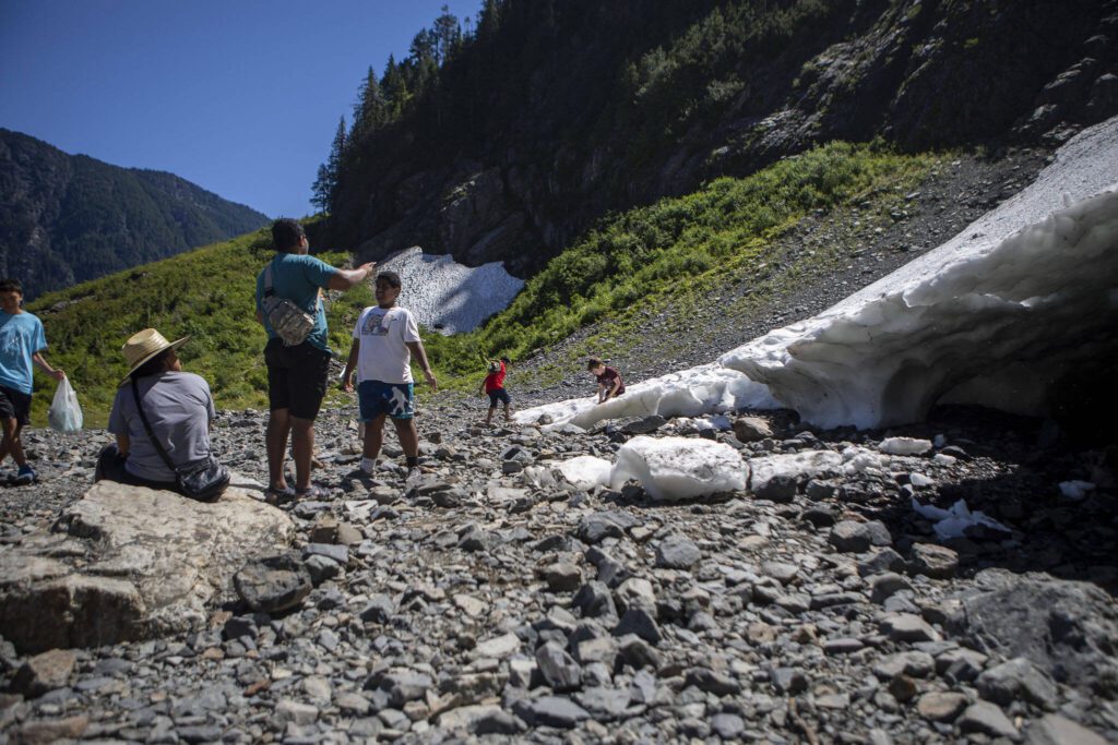 People explore at the Big Four Ice Caves along the Mountain Loop Highway in Snohomish County, Washington on Wednesday, July 19, 2023. (Annie Barker / The Herald)
