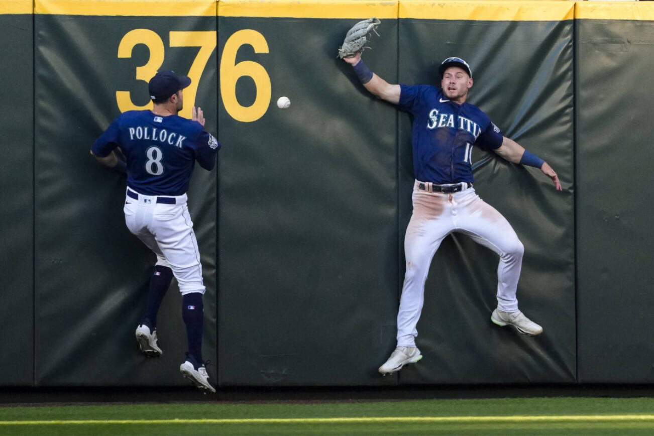 Seattle Mariners left fielder AJ Pollock (8) and center fielder Jarred Kelenic, right, can’t come up with triple by Minnesota Twins’ Alex Kirilloff during the fourth inning of Tuesday’s game in Seattle. (AP Photo/Lindsey Wasson)