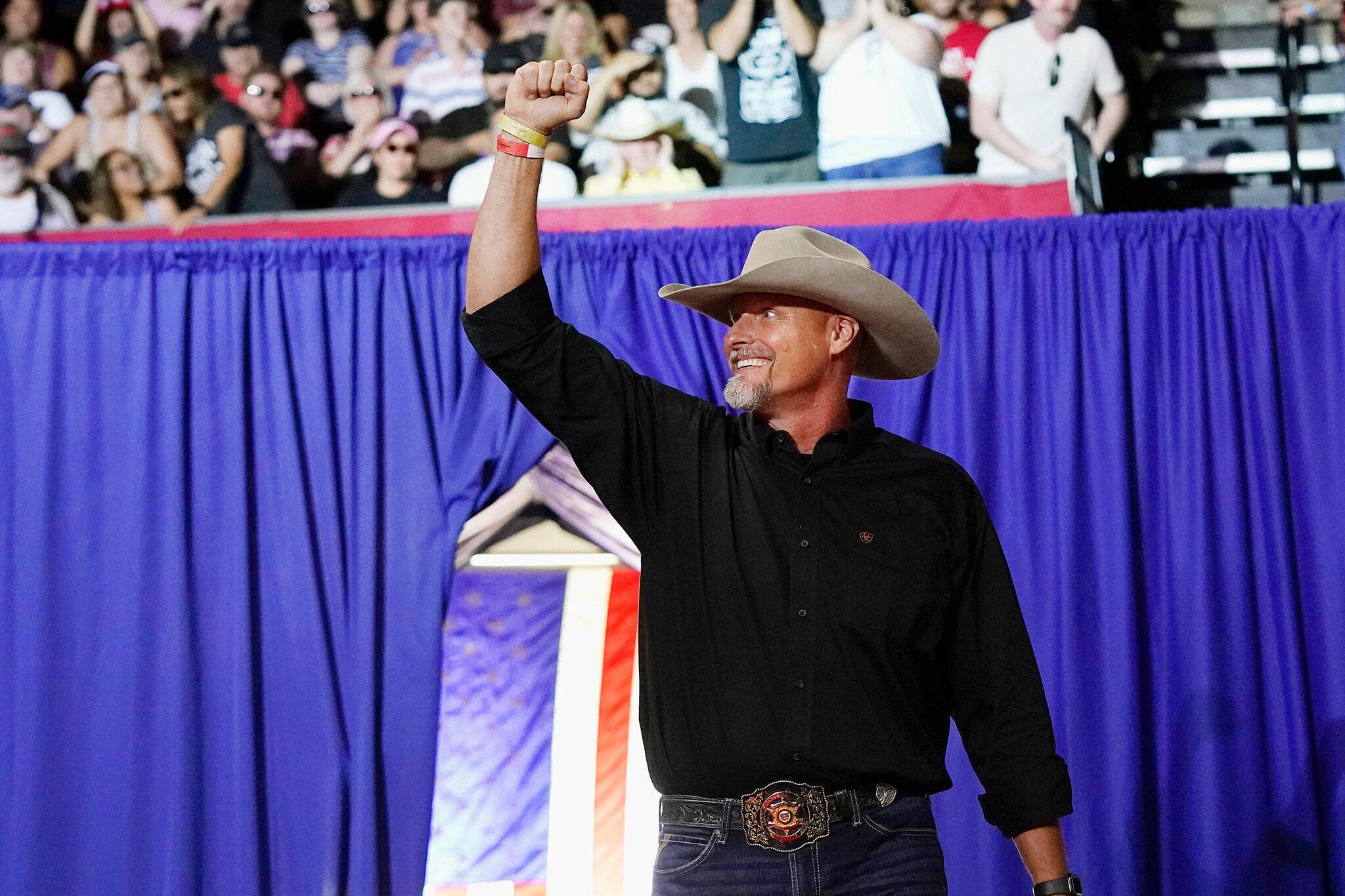 Pinal County sheriff Mark Lamb waves to a cheering crowd at a Save America Rally Friday, July 22, 2022, in Prescott, Ariz. (AP Photo/Ross D. Franklin)