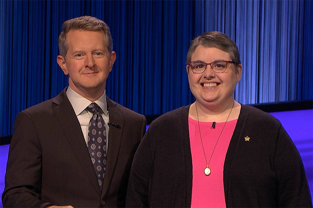 Julie Sisson, right, a library circulation assistant from Everett, stands next to “Jeopardy!” quiz show host Ken Jennings. (Photo courtesy of Jeopardy Productions, Inc.)