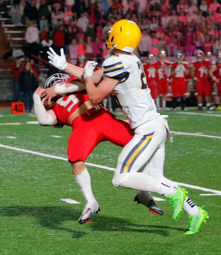 Stanwood’s Ryder Bumgarner comes down with a difficult interception against Ferndale on Oct. 21, 2022, at Stanwood High School in Stanwood. (Ryan Berry / The Herald)
