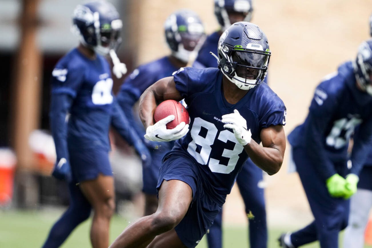 Seattle Seahawks wide receiver Dareke Young (83) runs the football during drills Monday, May 22, 2023, at the team's NFL football training facility in Renton, Wash. (AP Photo/Lindsey Wasson)