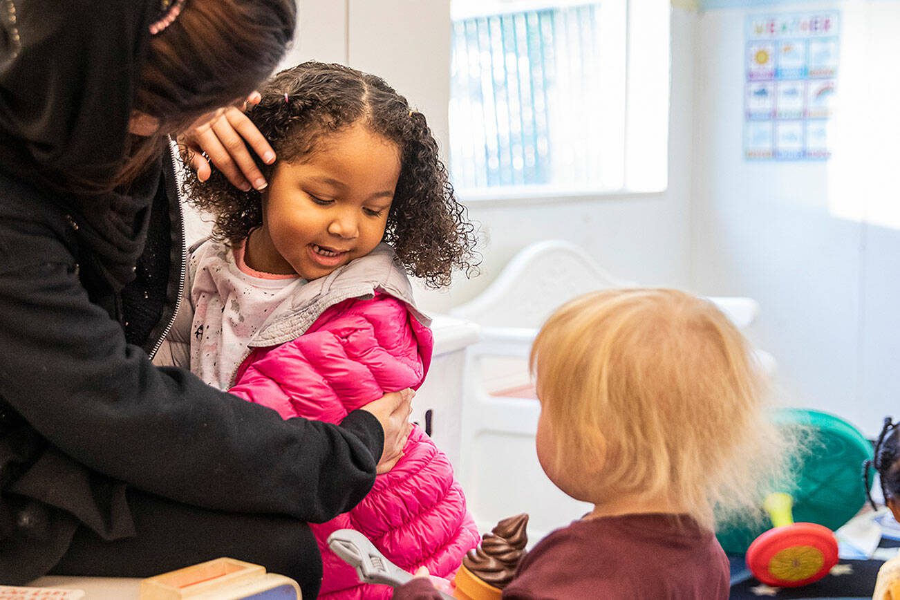 Katie, 3, gives a hug to one of her teachers at Tomorrow's Hope Child Development Center on Wednesday, Nov. 23, 2022 in Everett, Washington. (Olivia Vanni / The Herald)