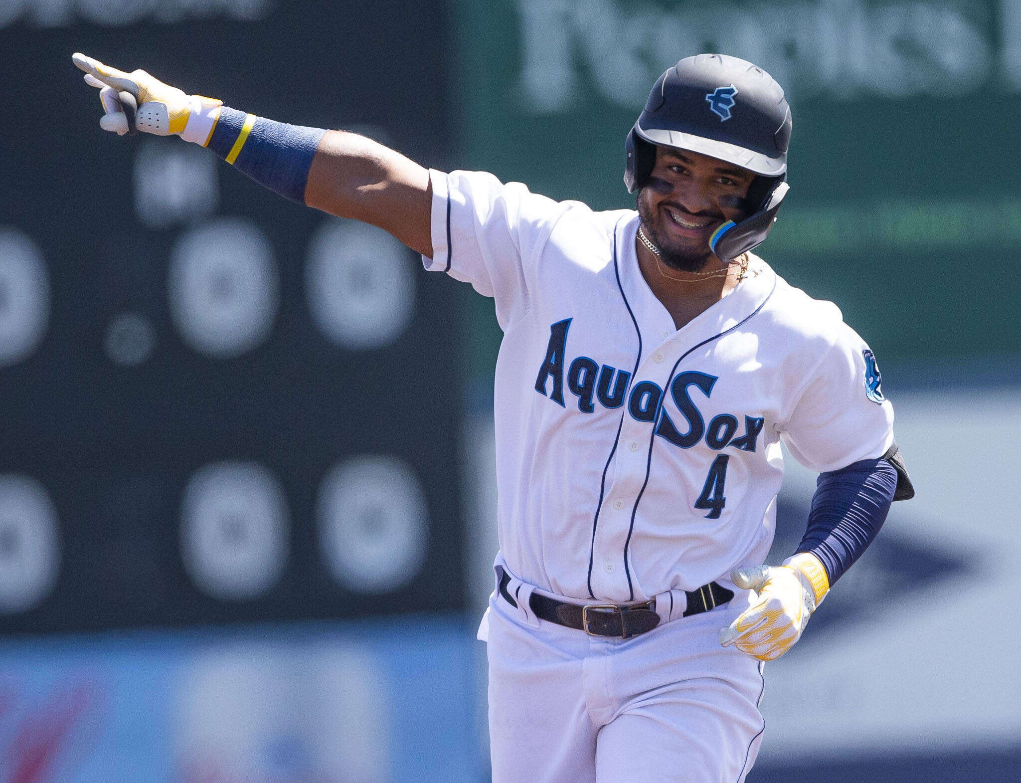 The AquaSox’s Gabriel Gonzalez points to the outfield and smiles after hitting a home run during a game against the Tri-City Dust Devils on July 19 in Everett. (Olivia Vanni / The Herald)