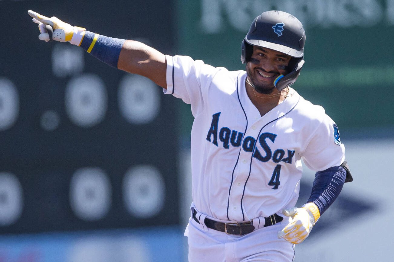 AquaSox’s Gabriel Gonzalez points to the outfield and smiles after hitting a home run during the game against the Tri-City Dust Devils on Wednesday, July 19, 2023 in Everett, Washington. (Olivia Vanni / The Herald)