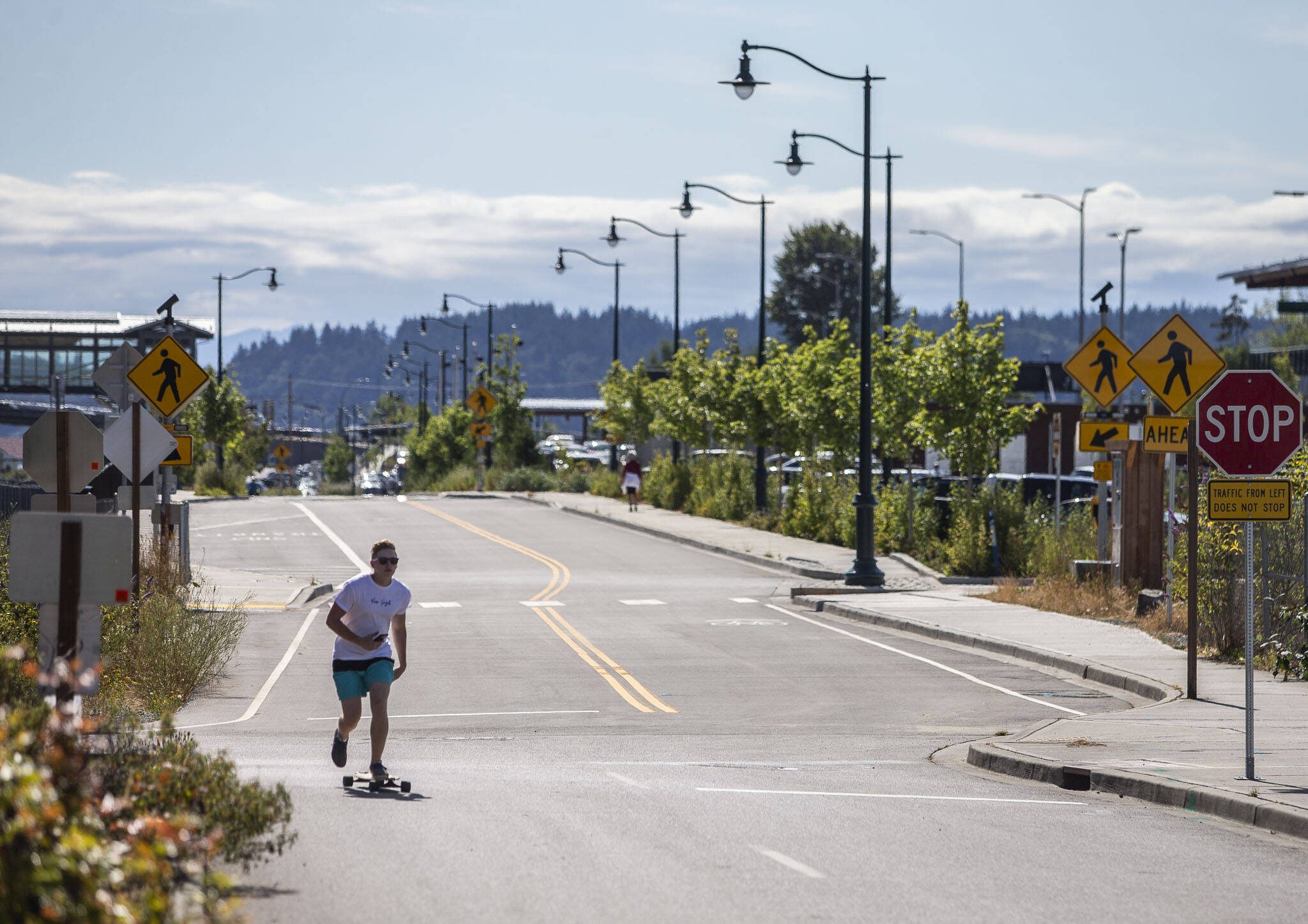 A longboarder rides down the newly opened First Street on Wednesday, July 26, 2023 in Mukilteo, Washington. (Olivia Vanni / The Herald)