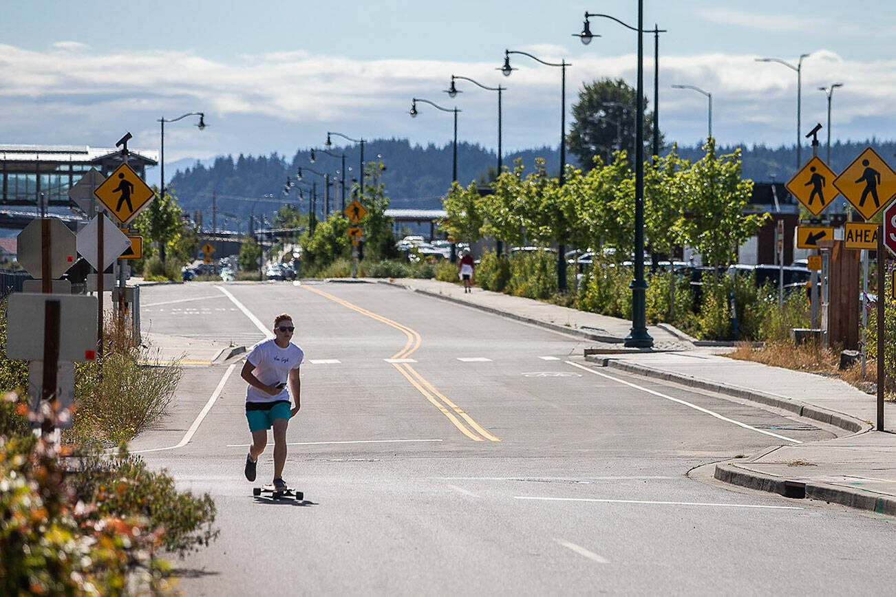 A longboarder rides down the newly opened First Street on Wednesday, July 26, 2023 in Mukilteo, Washington. (Olivia Vanni / The Herald)