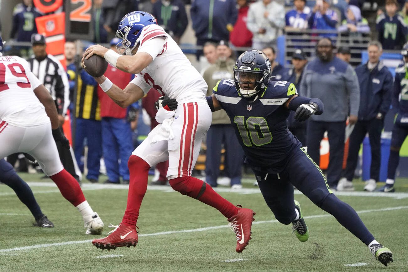 Seattle Seahawks linebacker Uchenna Nwosu (10) sacks New York Giants quarterback Daniel Jones during the second half of an NFL football game in Seattle, Sunday, Oct. 30, 2022. (AP Photo/Marcio Jose Sanchez)