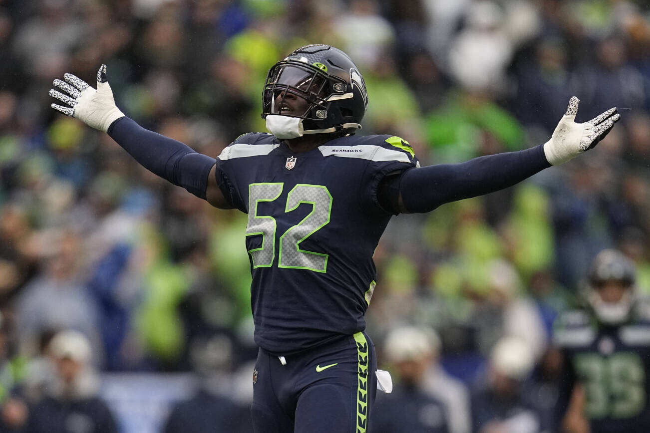 Seattle Seahawks defensive end Darrell Taylor (52) celebrates after his sack of Los Angeles Rams quarterback Baker Mayfield during the second half of an NFL football game Sunday, Jan. 8, 2023, in Seattle. (AP Photo/Abbie Parr)