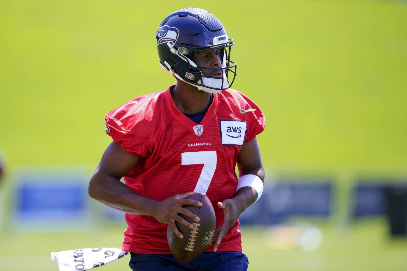 Seattle Seahawks quarterback Geno Smith holds a football during the NFL football team's training camp Thursday, July 27, 2023, in Renton, Wash. (AP Photo/Lindsey Wasson)