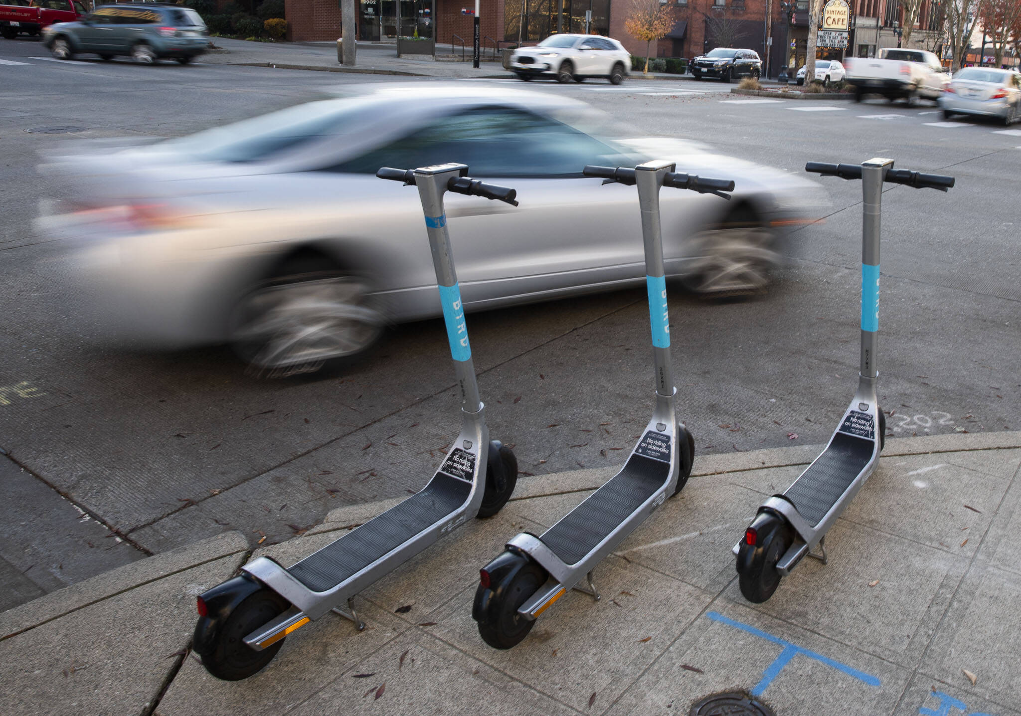 Bird scooters are lined up along the intersection of Colby Avenue and Hewitt Avenue in downtown Everett in November, one solution to reducing the abundance of cars on city streets. (Olivia Vanni / The Herald file photo)