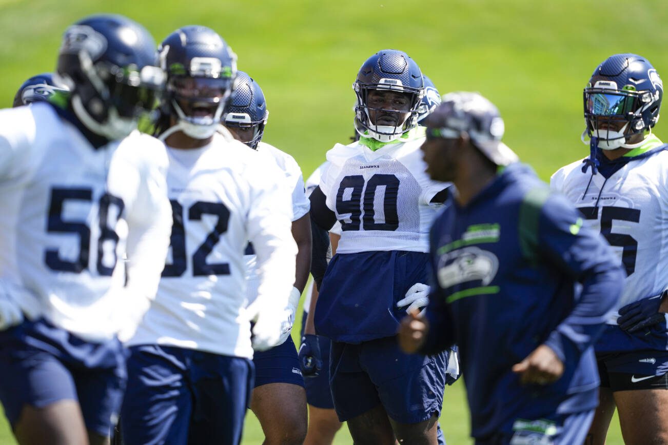 Members of the Seattle Seahawks defense, including defensive end Jarran Reed (90) practice during minicamp Tuesday, June 6, 2023, at the NFL football team's facilities in Renton, Wash. (AP Photo/Lindsey Wasson)