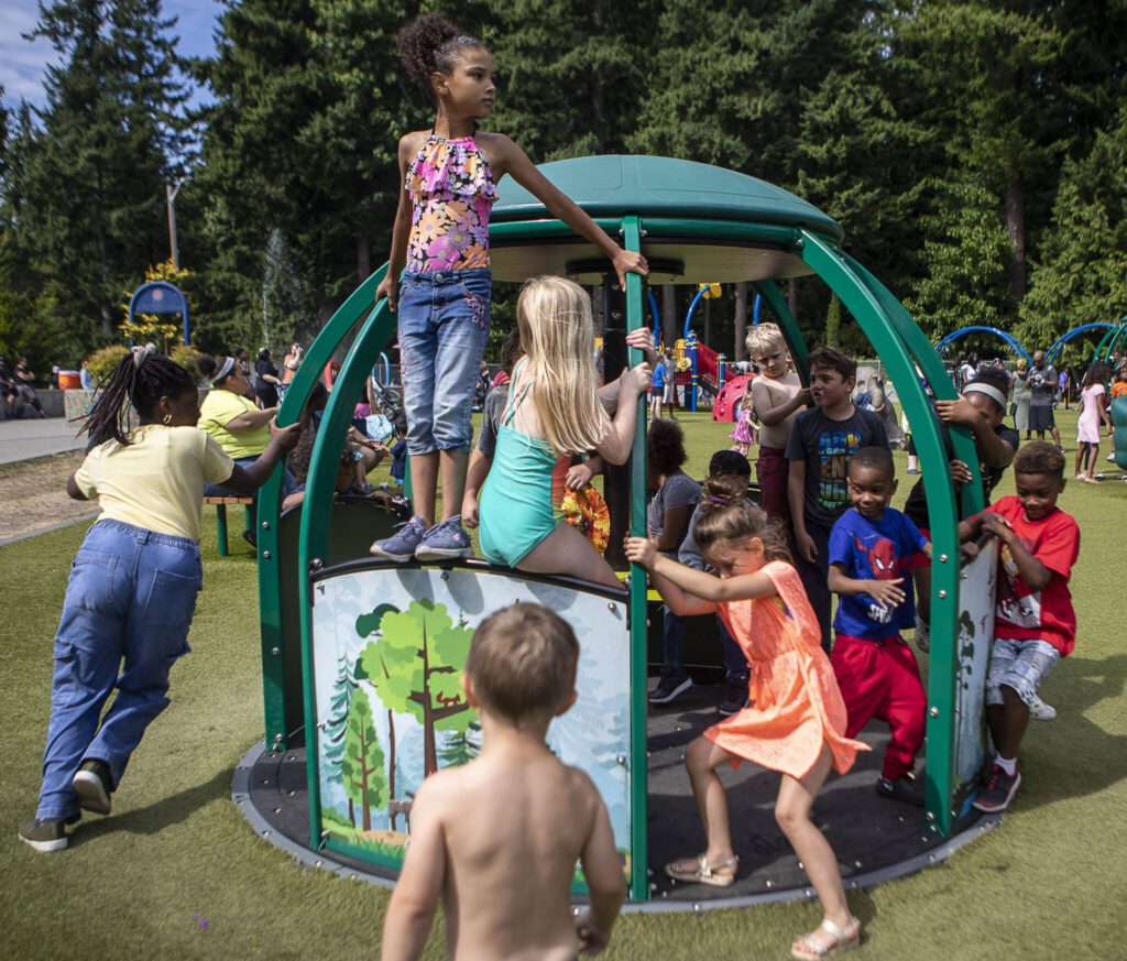 Children play together on a moving structure during the Nubian Jam at Forest Park in Everett, Washington on Saturday, July 29, 2023. (Annie Barker / The Herald)
