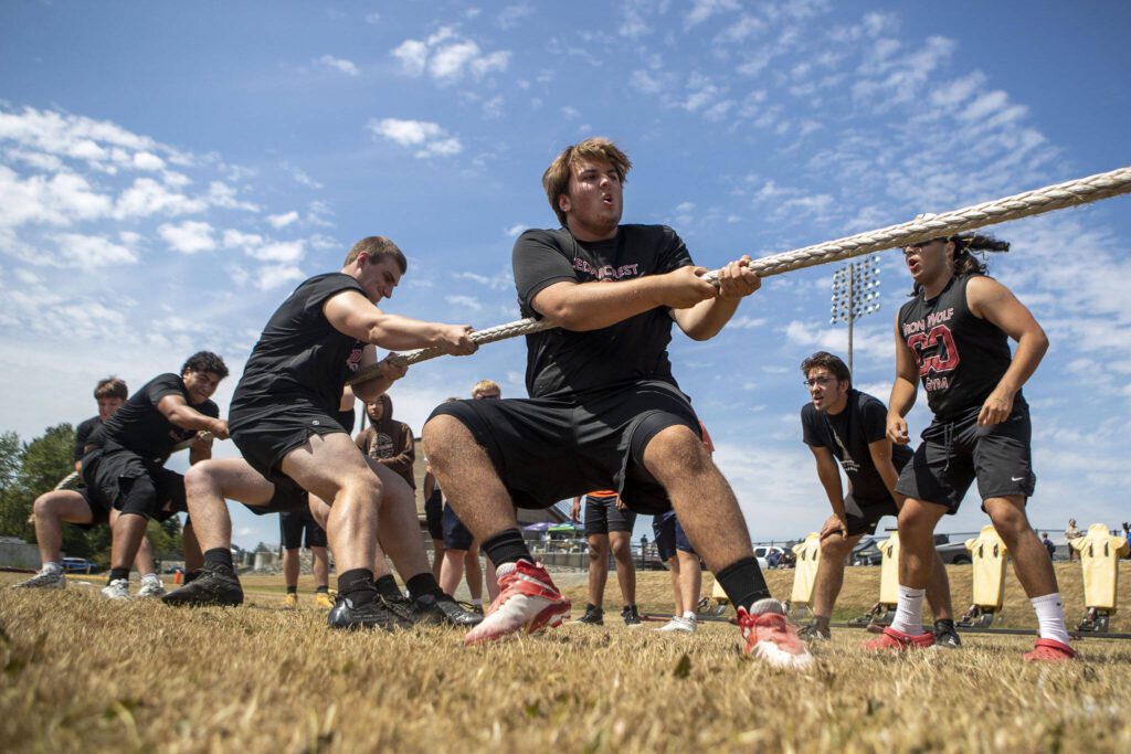 Cedarcrest players participate in the tug-of-war during the Lakewood 7on7 passing tournament and lineman challenge at Lakewood High School in Arlington, Washington on Saturday, July 29, 2023. (Annie Barker / The Herald)
