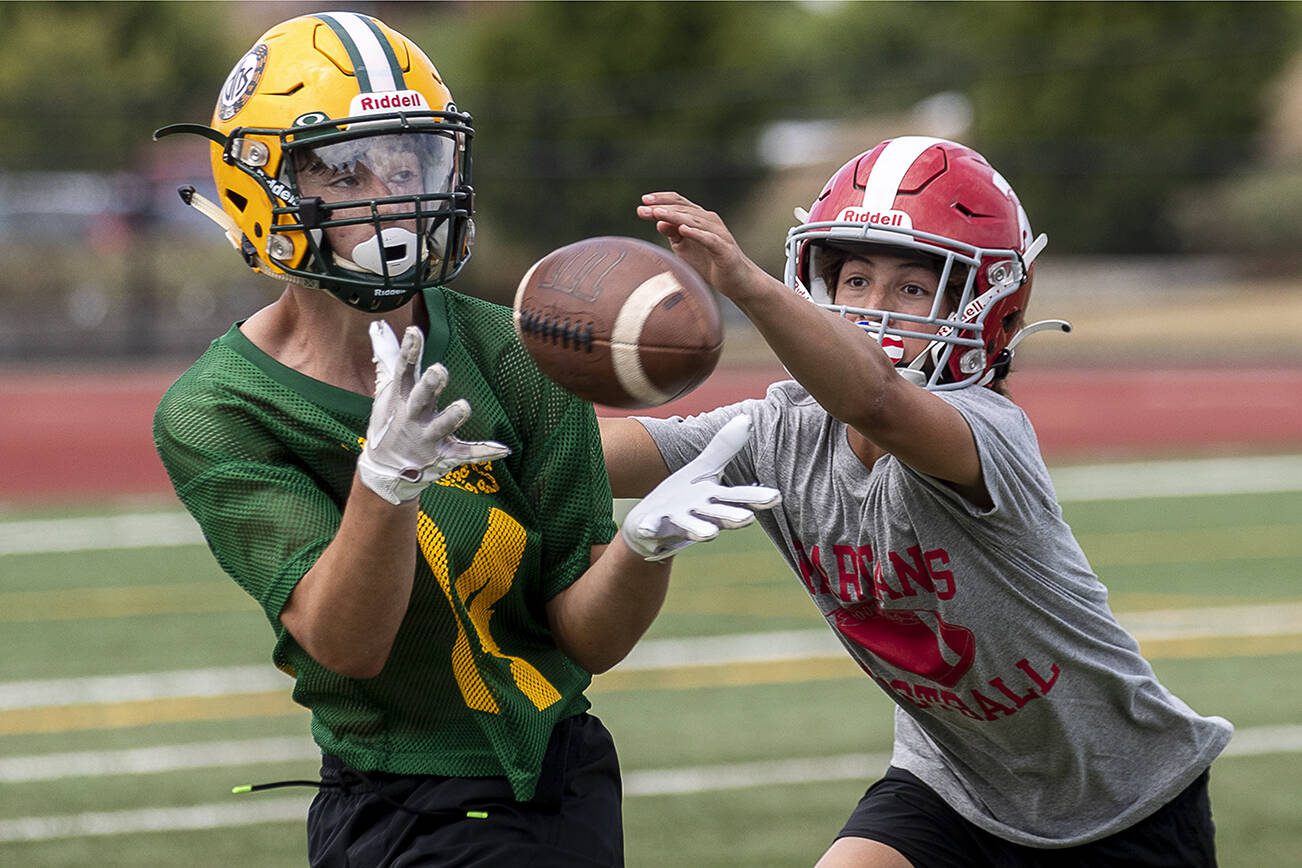 Darrington and Stanwood players fight for the ball during the Lakewood 7on7 passing tournament and lineman challenge at Lakewood High School in Arlington, Washington on Saturday, July 29, 2023. (Annie Barker / The Herald)