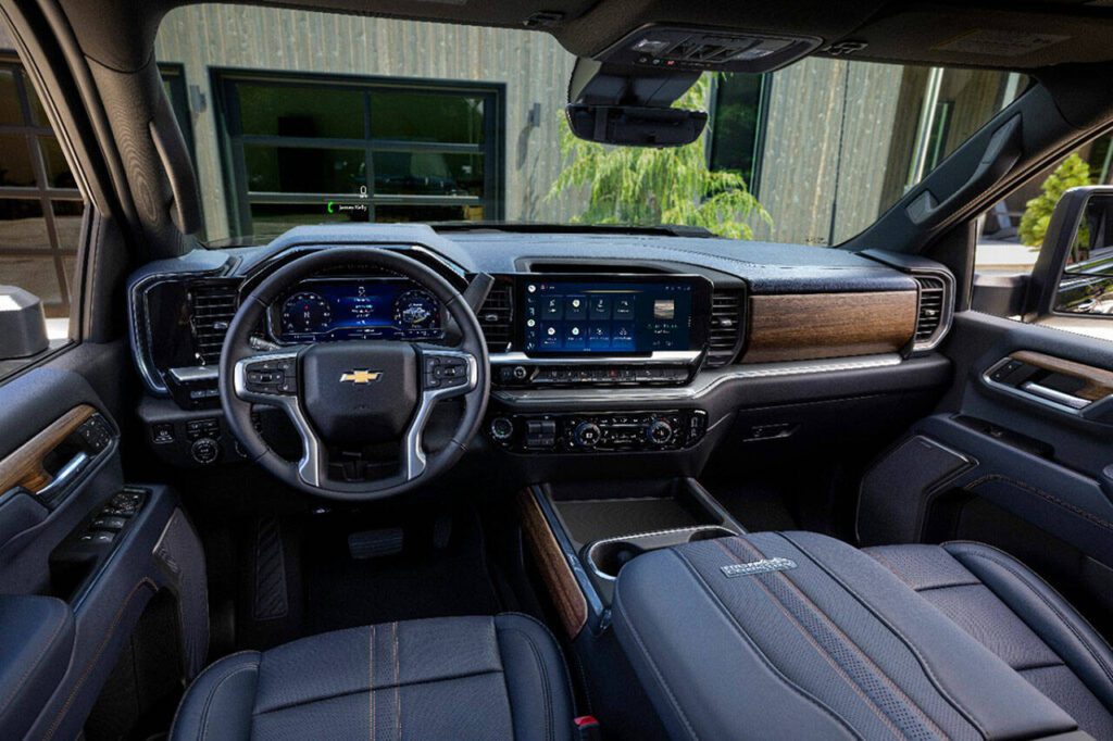 Front bucket seats are separated by a huge center console inside the 2024 Chevrolet Silverado 2500. The High Country interior is shown here. (Chevrolet)
