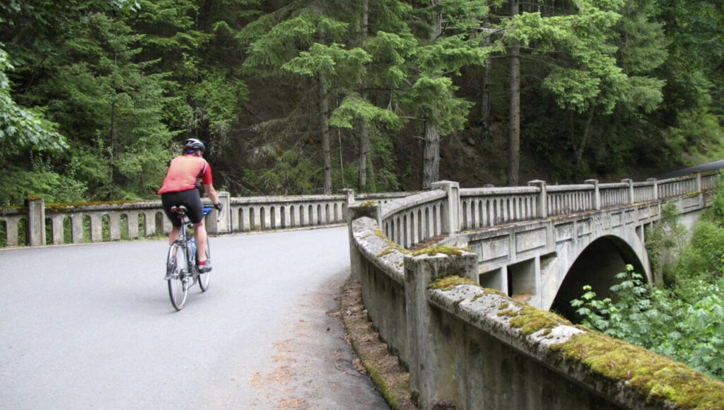 A cyclist rides across a bridge in Moran State Park on Orcas Island. The park covers 5,424 acres in the island’s interior. (Carey J. Williams / Associated Press)
